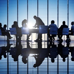 Silhouettes of business people in a conference room.