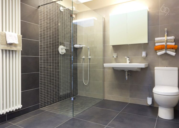A clean fresh modern shower room with wc basin mirrored cabinet and shower enclosure